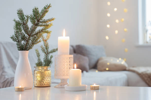 istock Christmas decorations with burning candles in white interior 1193012897