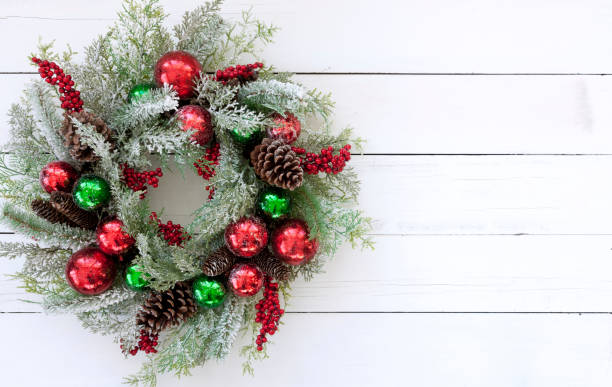 istock Christmas Wreath on an Old White Wood Background 1193012972