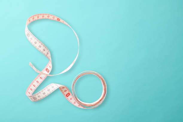 istock Measuring tape on light blue background 1193019156