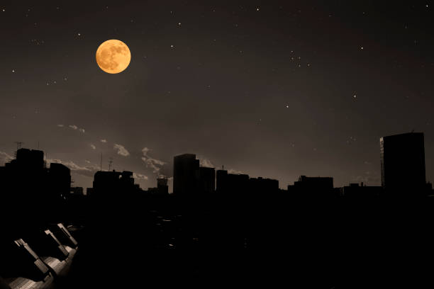 istock Full moon rising over the buildings 1193019172