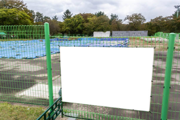 istock Blank billboard on fence of construction area 1193020564