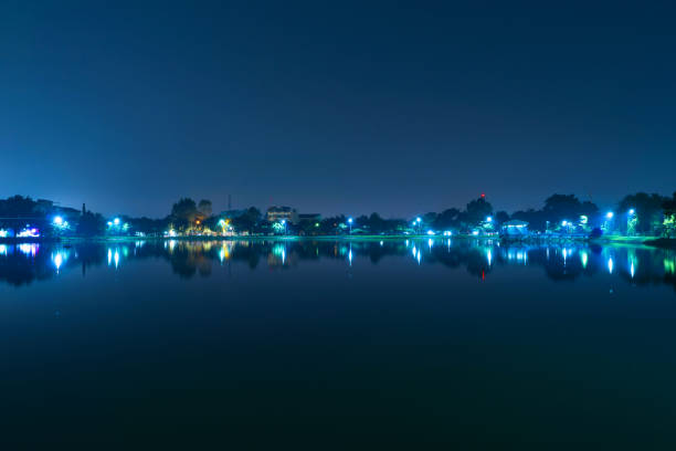 istock Residential buildings skyline with reflection in Phra Prathom Chedi district, Nakhon Pathom, Thailand. Urban city in Asia at night. Architecture landscape background. 1193022663