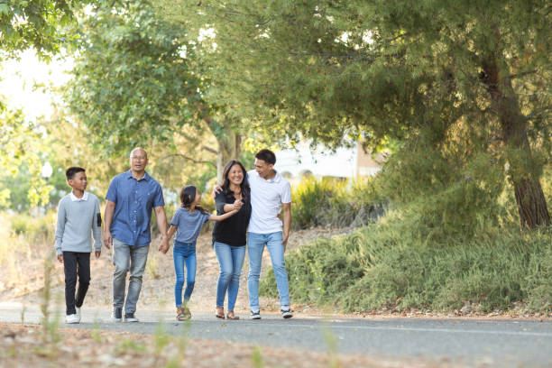 istock Happy Asian family walking and talking outside. 1193023749