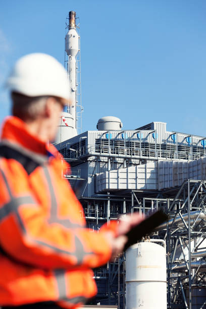 istock Petrochemical inspector with drawing 1193024801