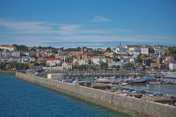 Scenic view of a bay in St. Peter Port in Guernsey, Channel Islands, UK ST. PETER PORT, GUERNSEY, UK - AUGUST 16, 2017: Scenic view of a bay in St. Peter Port in Guernsey, Channel Islands, UK. guernsey city stock pictures, royalty-free photos & images