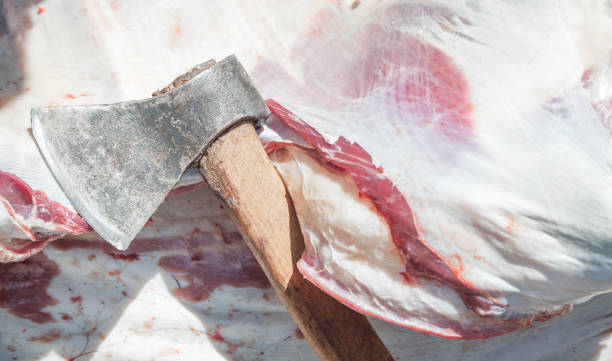 Raw meat with a ax. Cutting meat