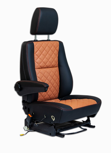 One sport seat of van with armrest with black and brown leather trim, located on the white isolated in the workshop for repair and tuning of cars and vehicles
