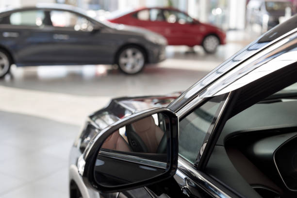 new cars at dealer showroom. themed blur background with bokeh effect. car auto dealership. - interior de transporte imagens e fotografias de stock