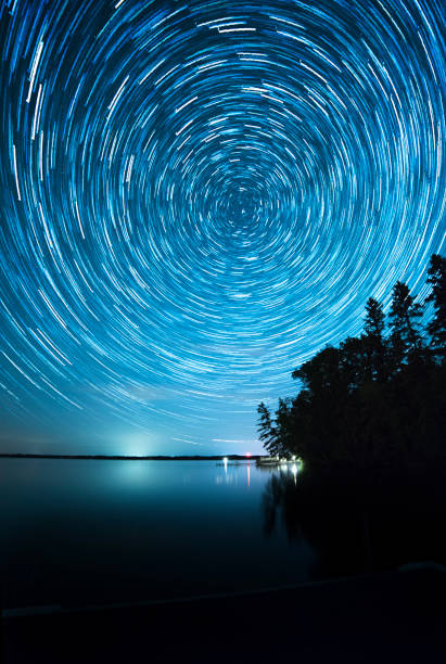 istock Star trails above a lake 1193028263