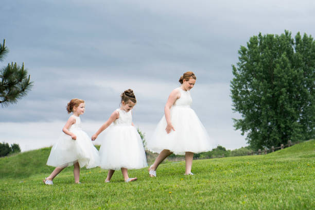 istock Three flower girls walking 1193028370