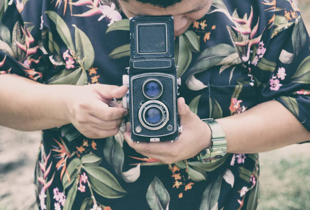 istock Man rotating vintage film camera with looking 1193028641