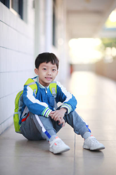istock Young boy reading at his desk in a classroom 1193029603