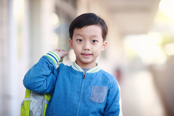 istock Young boy reading at his desk in a classroom 1193029658