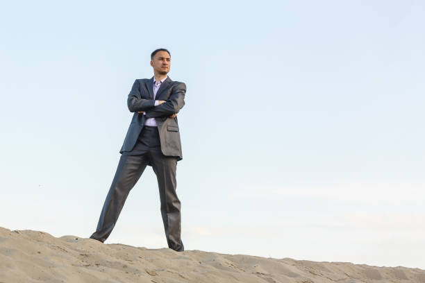 istock Handsome man elegantly dressed walking the desert 1193031588