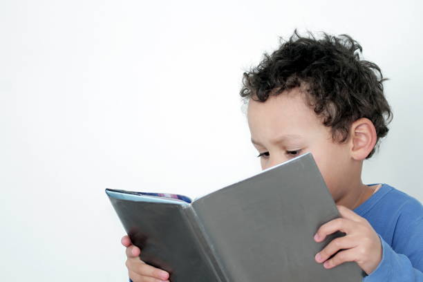 istock boy with school book stock photo 1193031887