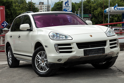 Novosibirsk, Russia - 07.10.2019: Front view of Porsche Cayenne 957 2007 in white color after cleaning before sale in a summer day on parking