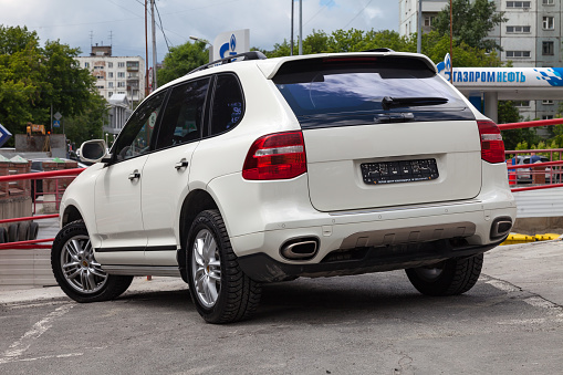 Novosibirsk, Russia - 07.10.2019: Rear view of Porsche Cayenne 957 2007 in white color after cleaning before sale in a summer day on parking