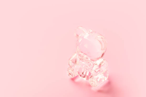 Cute crystal teddy bear toy on pink background