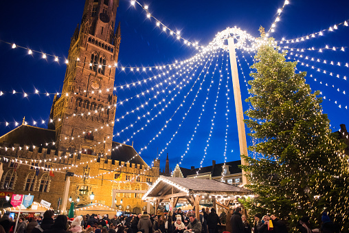 Bruges, Belgium - November, 30, 2019 - Traditional Christmas market with decorated Christmas tree at the main square of Bruges, Flanders, Belgium