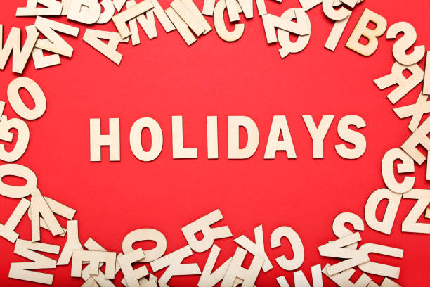 istock Word Holidays by wooden letters on red background 1193033664