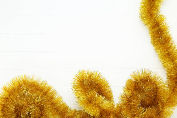 istock Christmas tinsel on white wooden table 1193038183