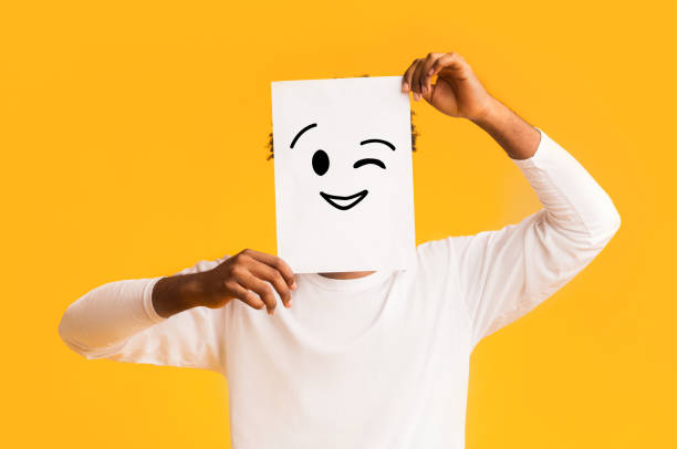 istock Afro guy holding paper with positive emoji 1193038289