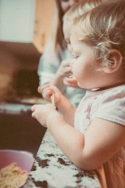istock Close up image of kids playing with boiled pasta 1193038655