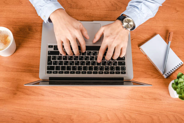 A man working in the office at the computer. Workplace Director or entrepreneur. Flat lay
