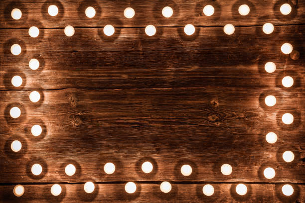 istock Vintage wooden background with tea light candles border 1193041224