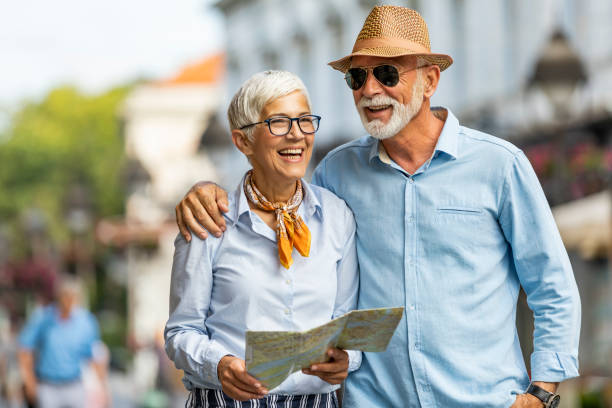 istock Active Senior Tourists are Walking Through the City Streets with Map 1193044062
