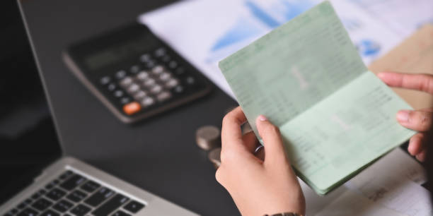 istock Closeup woman looking her saving account book. 1193044116
