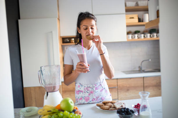 istock Smiling woman drinking smoothie 1193044289