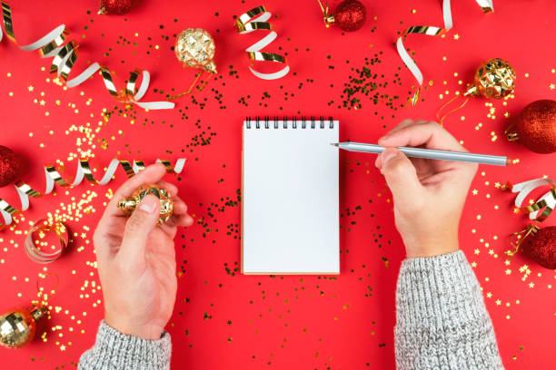 istock Holiday background with white Notepad sheet and male hands with pen. 1193046394