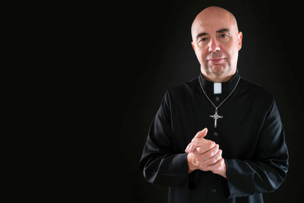 istock friendly priest honling hands portrait with cassock 1193047440