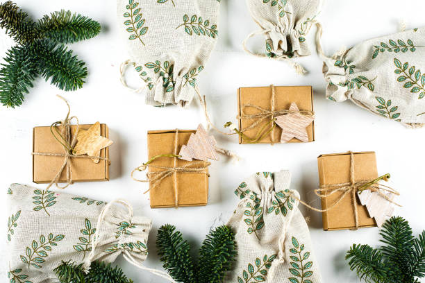 istock Christmas composition Craft Boxes and Pouches with fir branch on white background. Zero Waste Gift Wrapping Holiday Season Eco-friendly. Top view, flat lay 1193047494