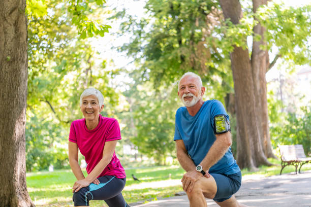 istock Active Senior Couple is Stretching Outdoors in Nature 1193047629