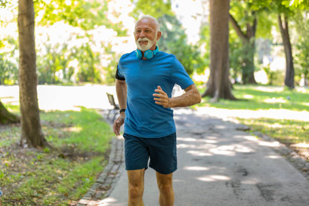 istock Handsome Mature Man is Jogging Outdoors in Nature 1193047790