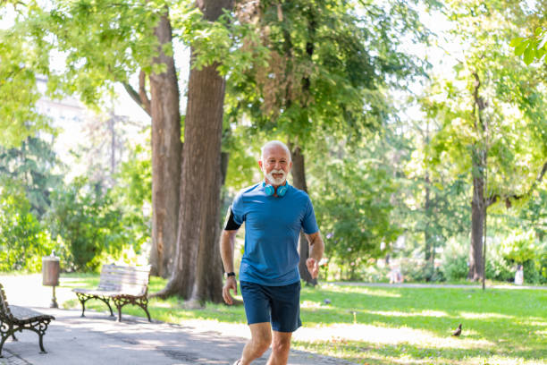 istock Handsome Mature Man is Jogging Outdoors in Nature 1193047800