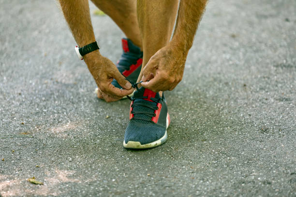 istock Senior Athlete Tying Sneaker Shoe 1193048055