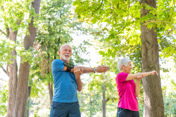istock Active Senior Couple is Stretching Outdoors in Nature 1193048857