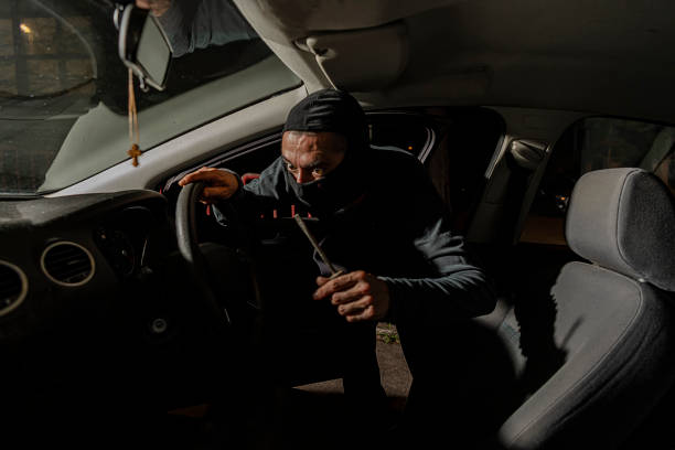 istock Burglar Entering a Car During the Night Hours 1193049894