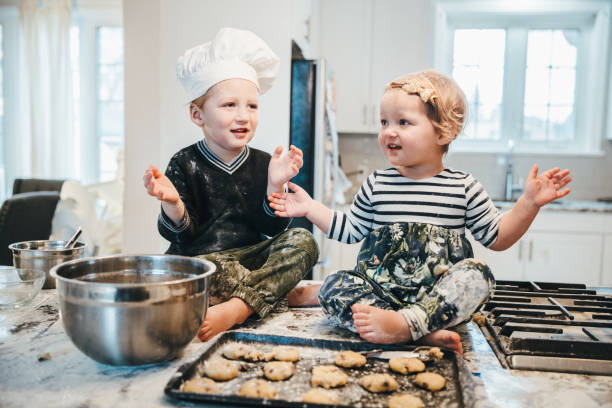 istock It is all about team work sister! Little Chefs at work 1193056670