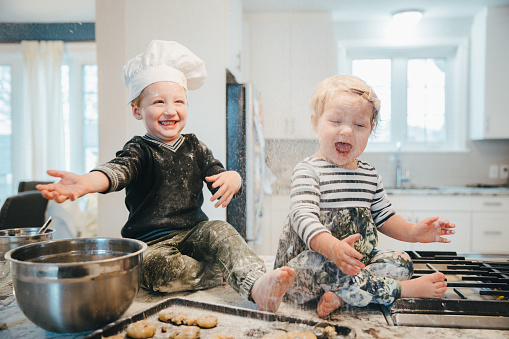 Toddler, Baby Girl, Baking, Kitchen - Baby boy throwing flour at his sister to annoy her