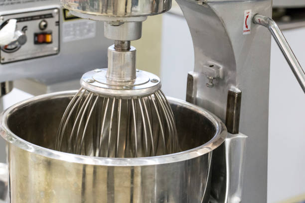 Stainless steel electric mixer in bakery stock photo