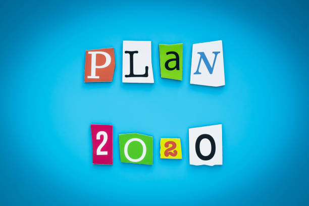 istock Plan-2020. Text on a blue background, multicolor paper letters. Inscription. The planning concept. Single word on banner. 1193058286