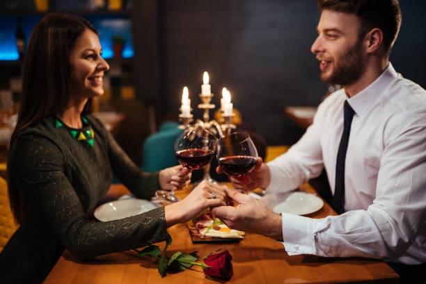istock Couple holding hands during romantic dinner in a restaurant 1193060313