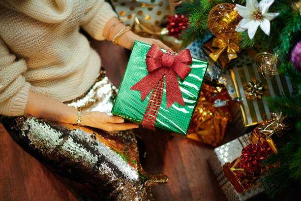 istock young woman showing Christmas present box 1193060792