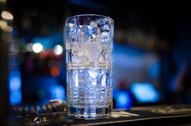 istock Glass with ice cubes on bar counter 1193064157