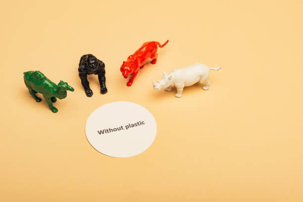 istock Colored toy animals with lettering without plastic on card on yellow background, environmental pollution concept 1193064485