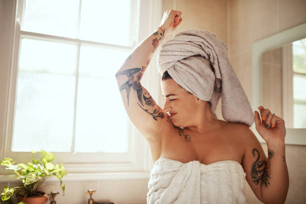I might need to change deodorants Shot of an attractive young woman smelling her armpits during her morning beauty routine body odor stock pictures, royalty-free photos & images